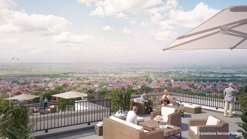Dachterrasse mit Sitzbereich, Sonnenschirmen und Blick über eine weitläufige Stadtlandschaft.